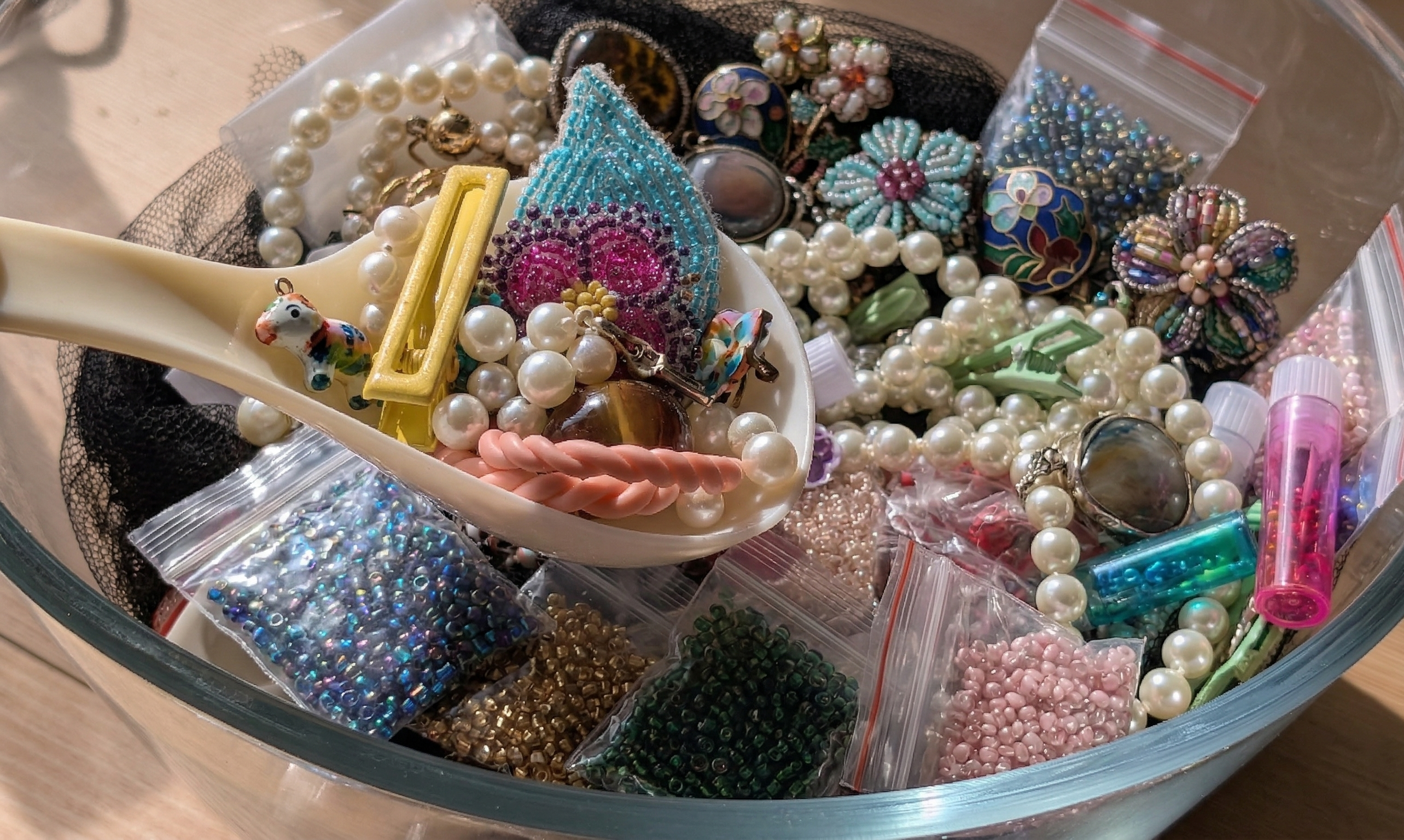 image d'un scoop sur laquelle sont posés divers objets, tels qu'une barrette, des bagues et des boucles d'oreilles 